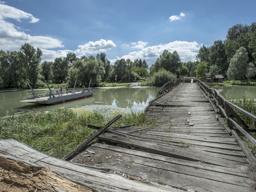 A ruined bridge close to Liberland. The only possibility to cross the river is the small ferry in the background.