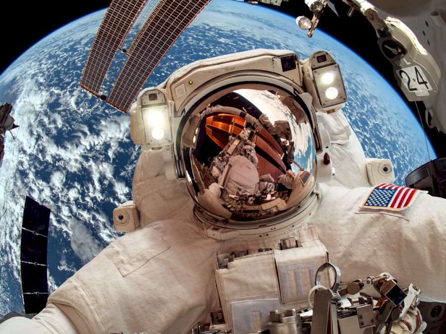 International Space Station and astronaut in outer space over th